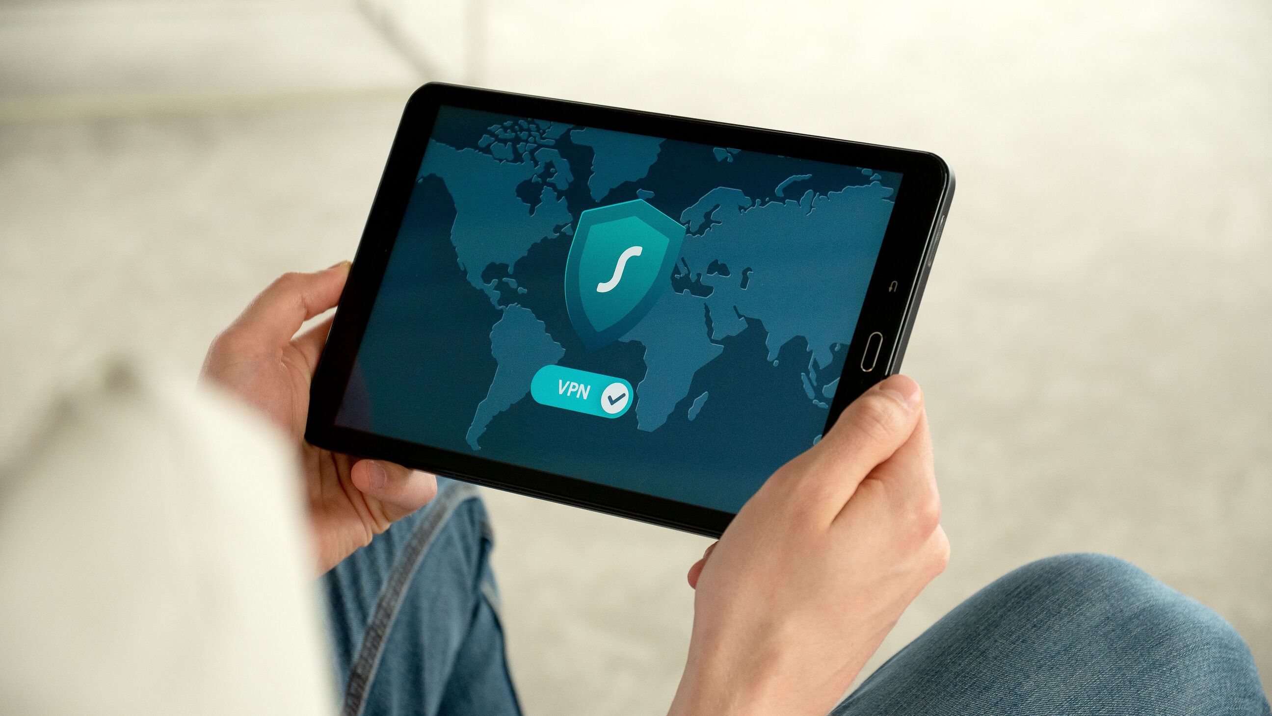 Tablet displaying a VPN security shield, representing an MDM security checklist for protecting enterprise mobile devices, remote work, and data security.